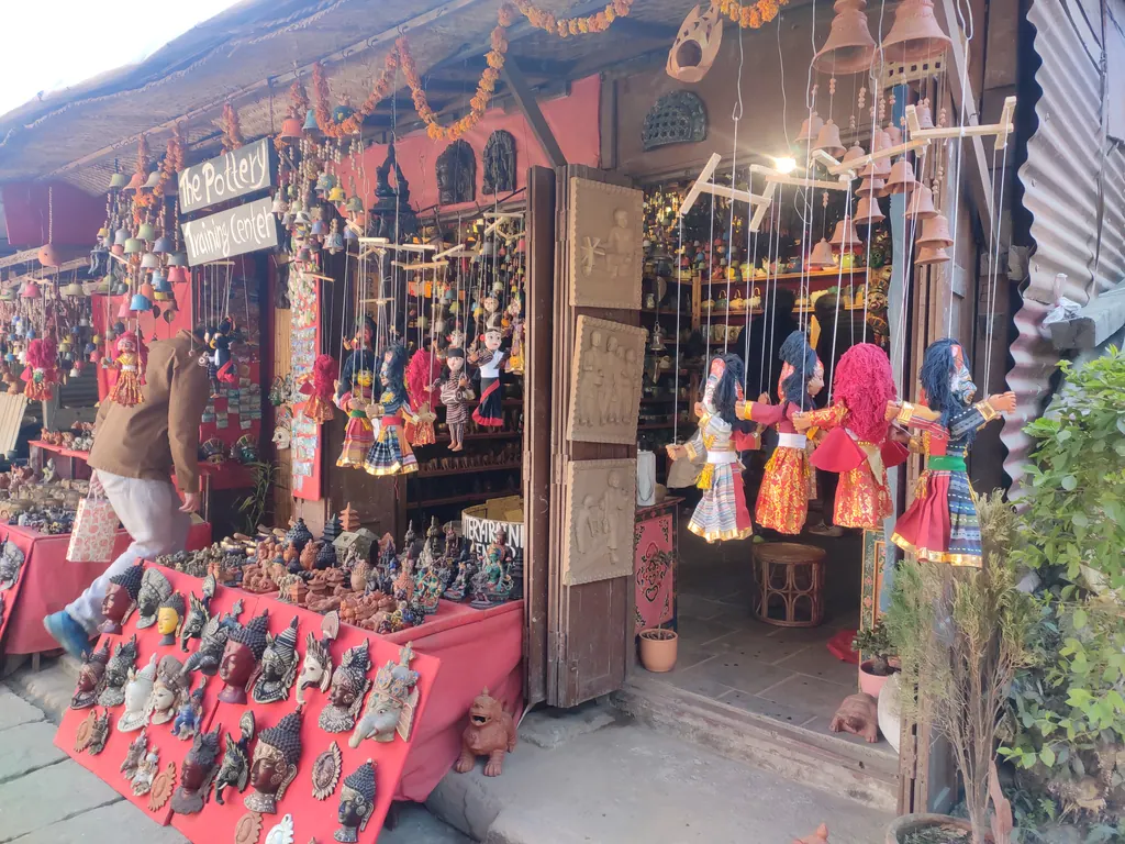 Craft shop near Bhaktapur's Pottery Square with puppets, masks and hanging ornaments on display